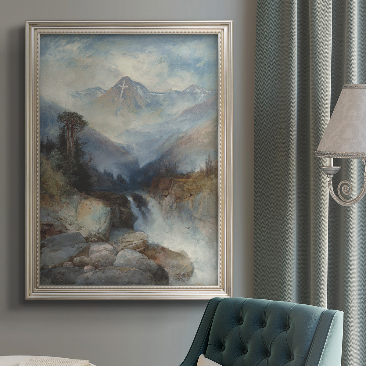 Romantic landscape painting of the Rocky Mountains by Thomas Moran in an {frame_style_descriptor} displayed in a neutral interior setting.