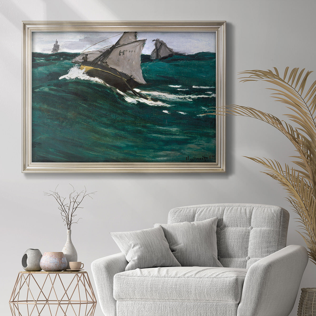 Impressionist seascape with crashing green wave by Claude Monet in an ornate champagne frame displayed in a bright interior setting.
