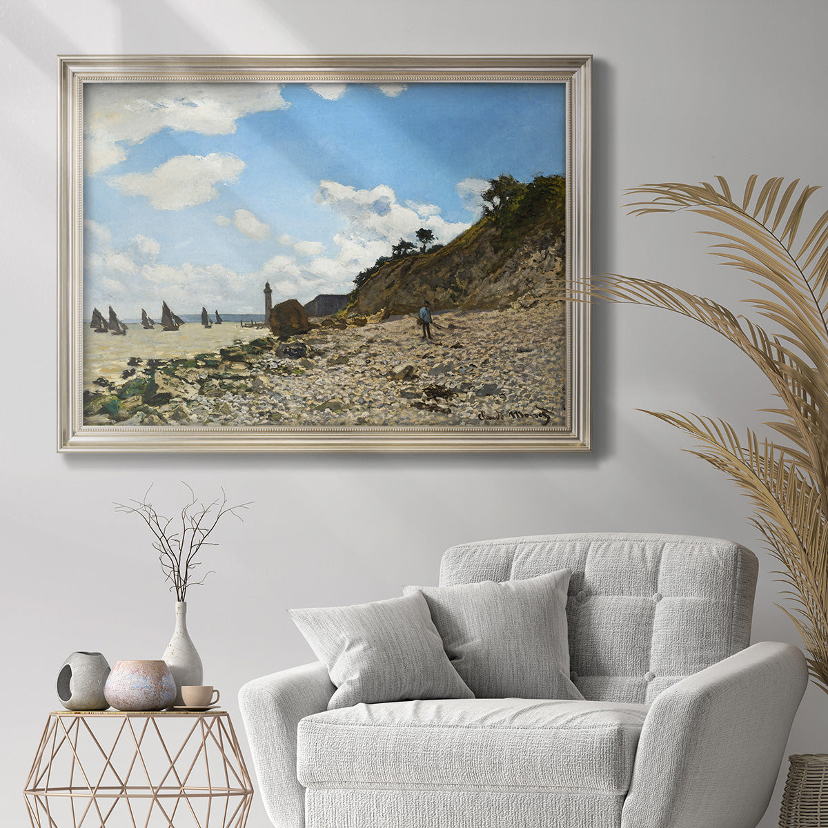 Impressionist beach landscape at Honfleur by Claude Monet in an ornate champagne frame displayed in a bright interior setting.