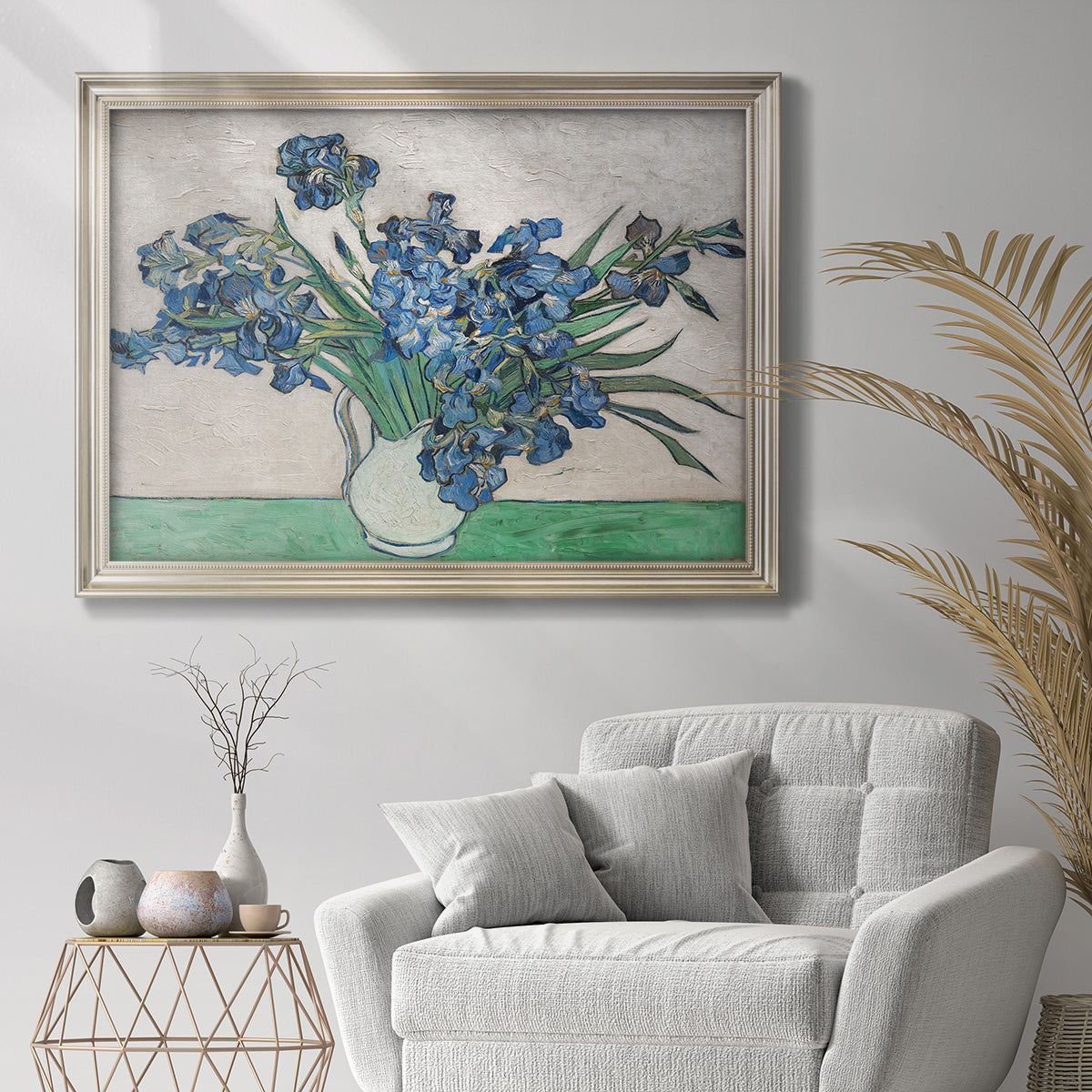 Impressionist iris flower painting by Vincent van Gogh in an ornate champagne frame displayed in a bright interior setting.