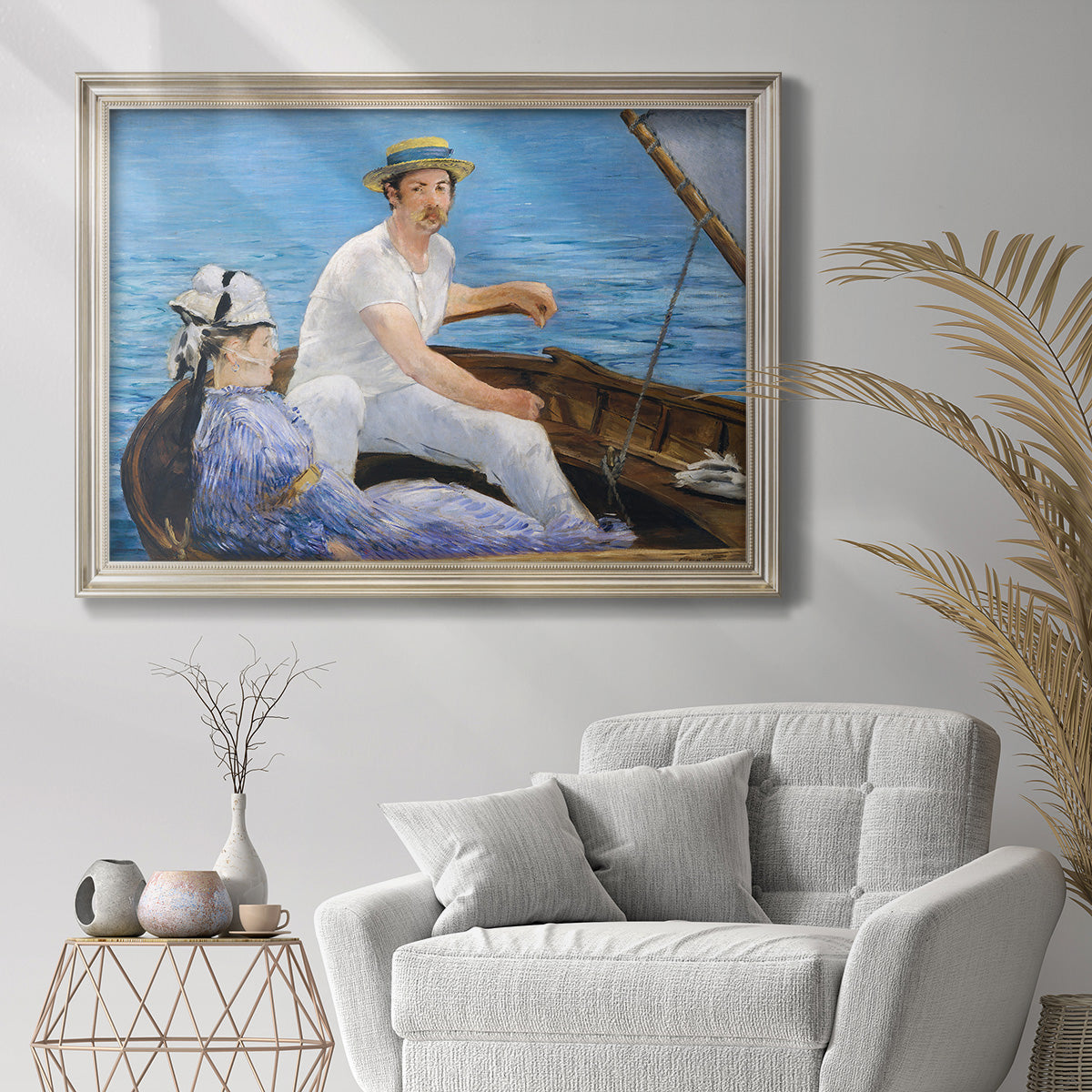 Impressionist leisure boating scene by Édouard Manet in an ornate champagne frame displayed in a bright interior setting.