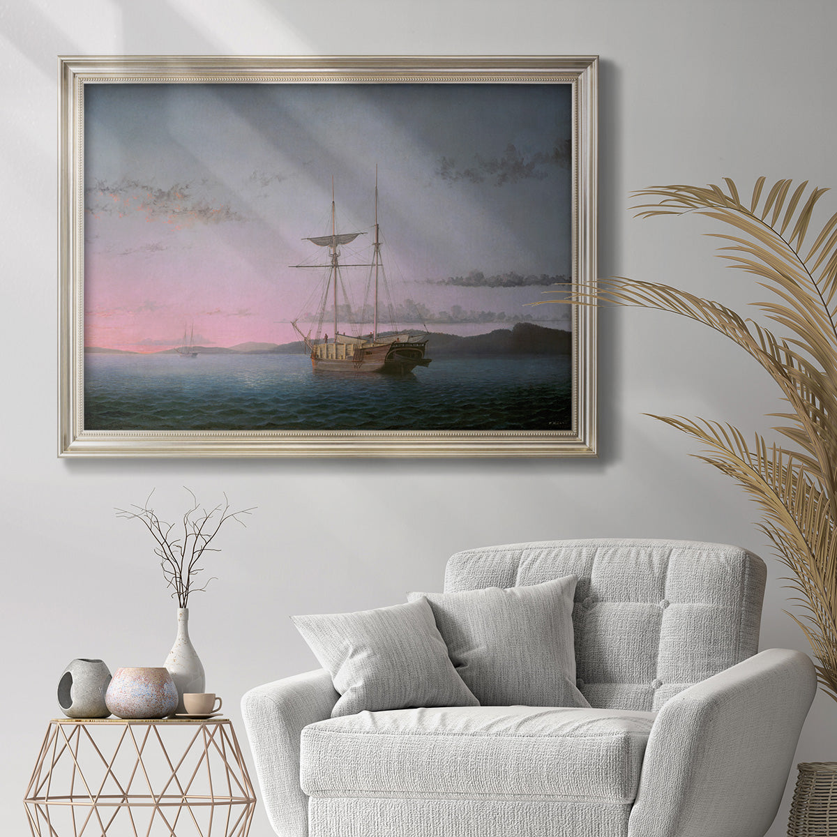 Coastal nautical scene with schooners at dusk by Fitz Henry Lane in an ornate champagne frame displayed in a bright interior setting.