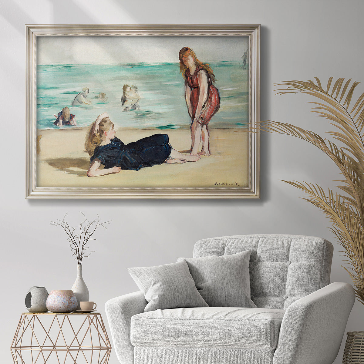 Impressionist beach leisure scene by Édouard Manet in an ornate champagne frame displayed in a bright interior setting.