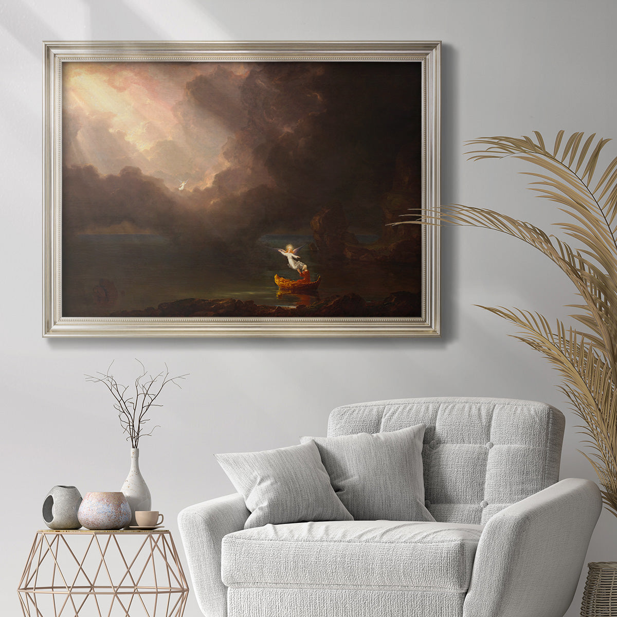 Allegorical landscape painting from the Voyage of Life series by Thomas Cole in an ornate champagne frame displayed in a bright interior setting.
