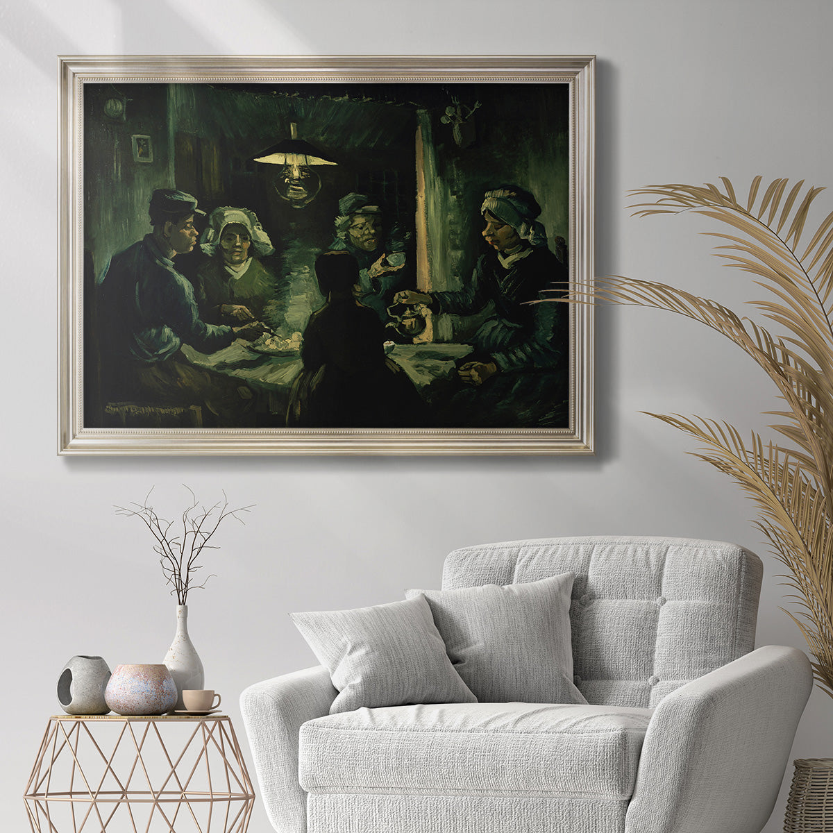 Early expressive study of peasant figures by Vincent van Gogh in an ornate champagne frame displayed in a bright interior setting.