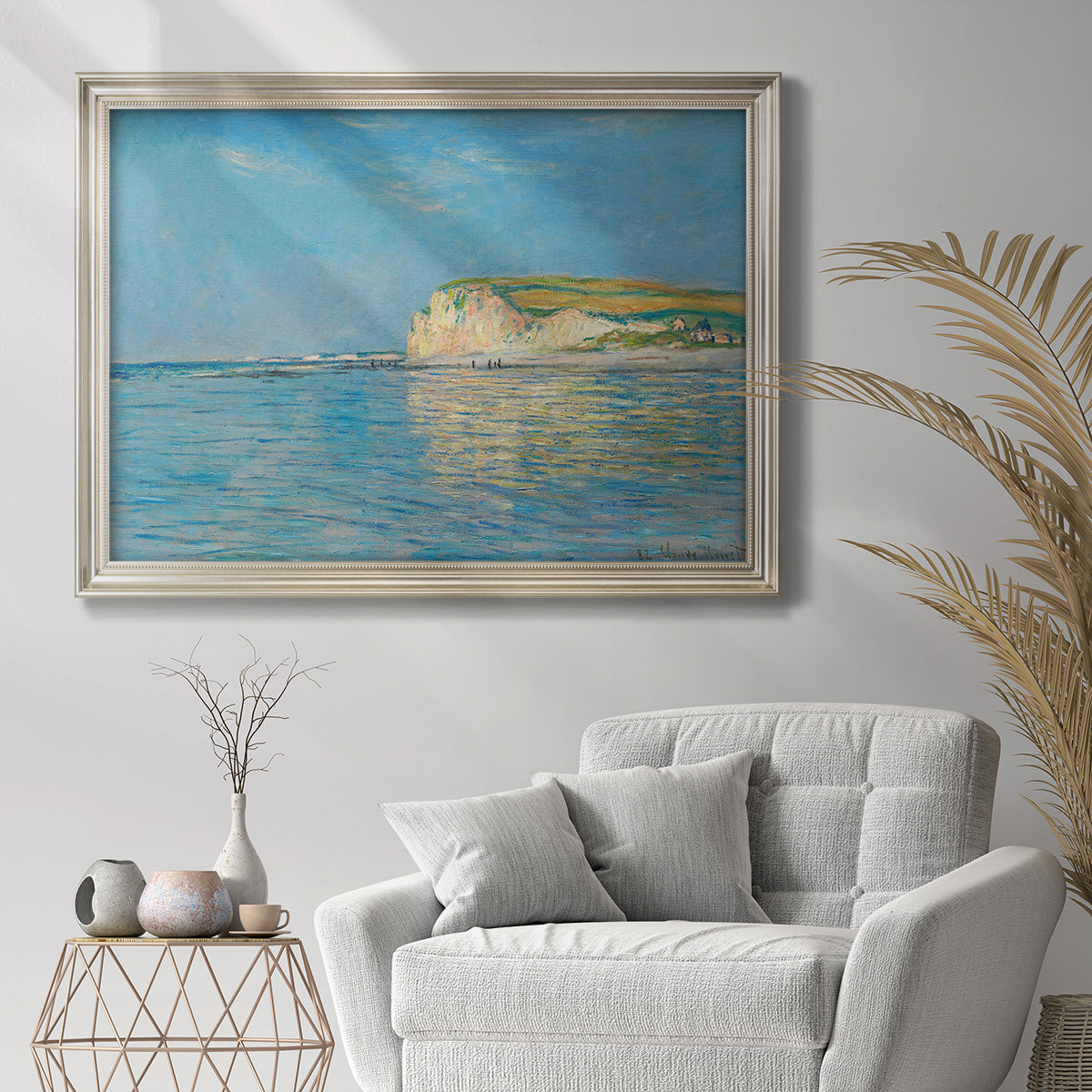 Impressionist coastal low-tide seascape at Pourville by Claude Monet in an ornate champagne frame displayed in a bright interior setting.