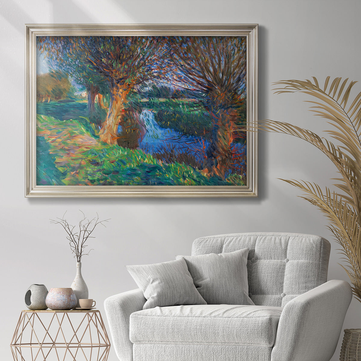 Impressionist countryside landscape by John Singer Sargent in an ornate champagne frame displayed in a bright interior setting.