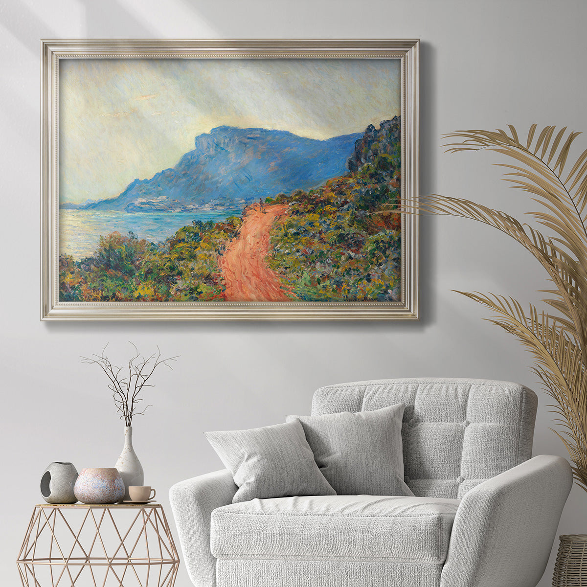 Impressionist Riviera coastal landscape near Monaco by Claude Monet in an ornate champagne frame displayed in a bright interior setting.