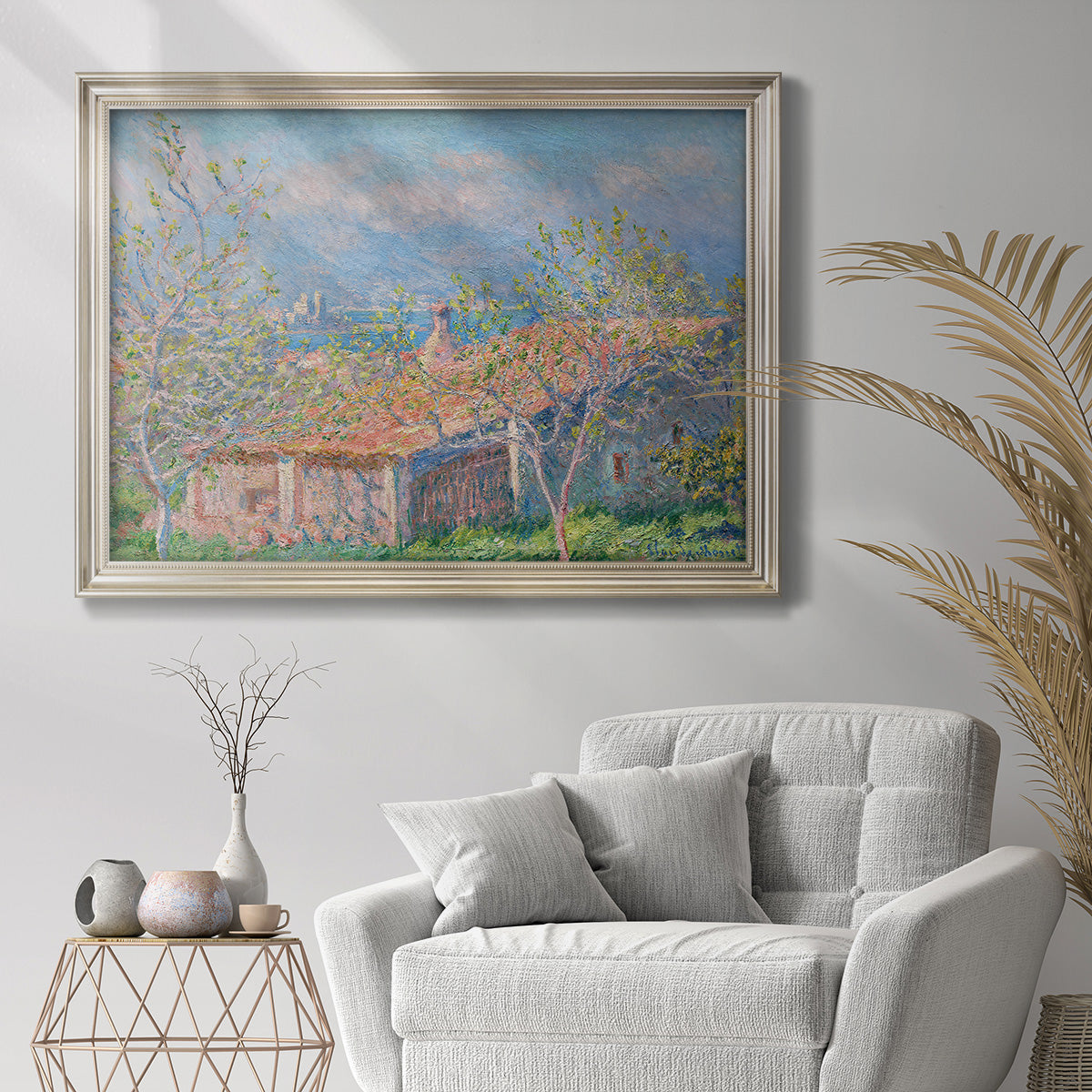 Impressionist garden house landscape at Antibes by Claude Monet in an ornate champagne frame displayed in a bright interior setting.