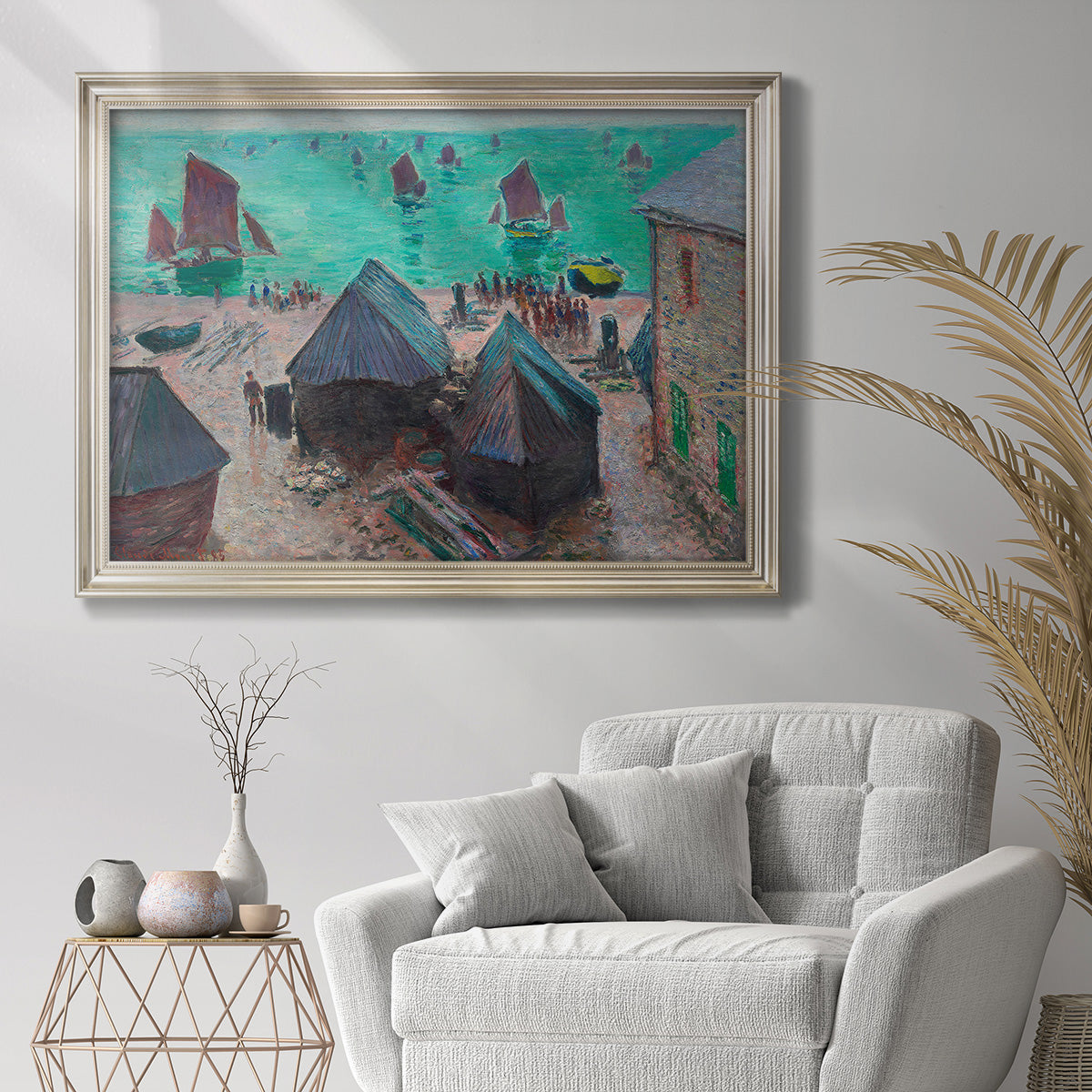 Impressionist coastal harbor scene at Étretat by Claude Monet in an ornate champagne frame displayed in a bright interior setting.