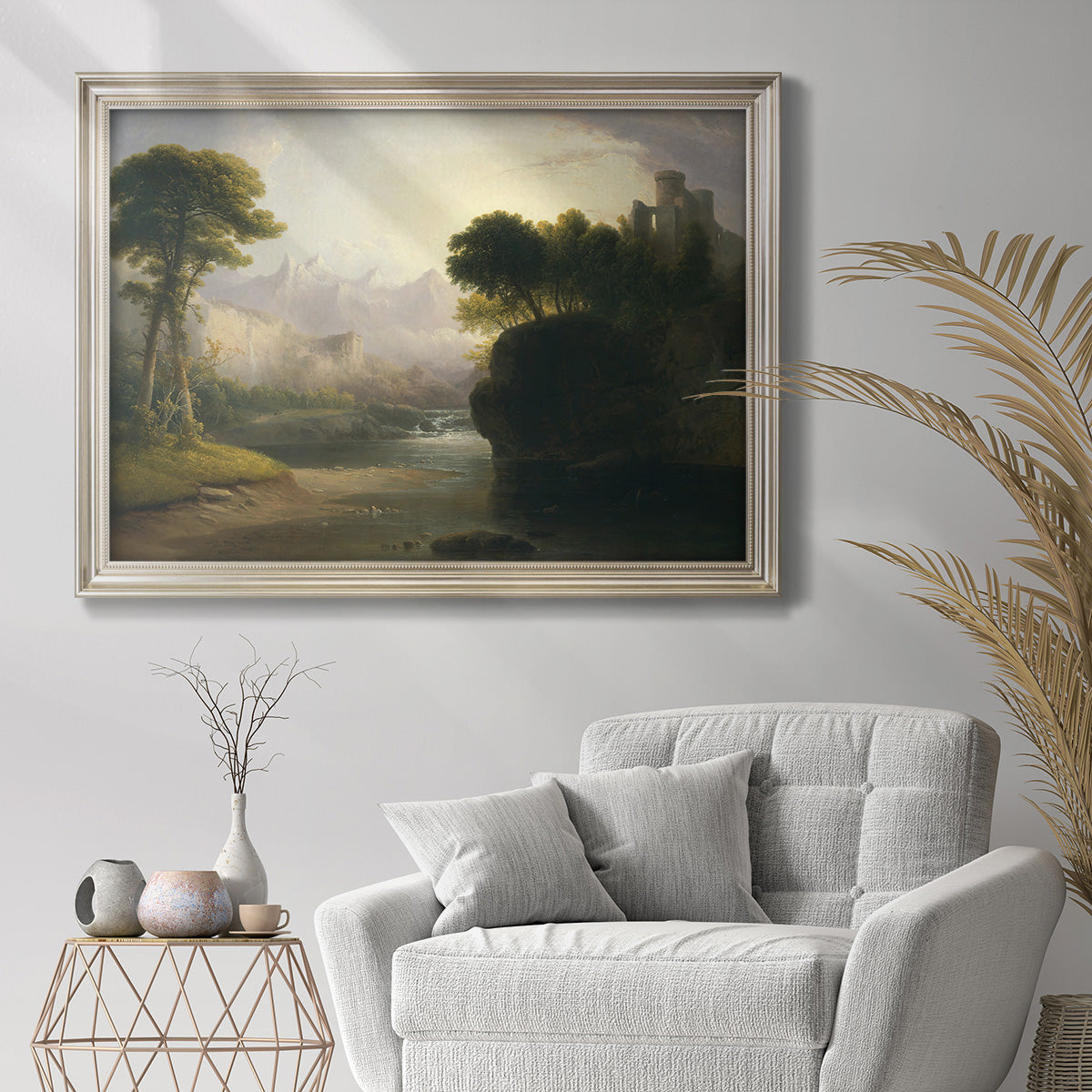 Romantic autumn landscape along the Hudson River by Thomas Doughty in an ornate champagne frame displayed in a bright interior setting.