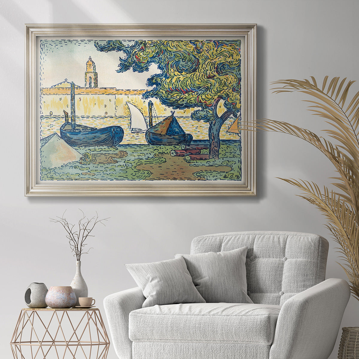 Impressionist harbor scene at Saint-Tropez by Paul Signac in an ornate champagne frame displayed in a light-toned interior setting.