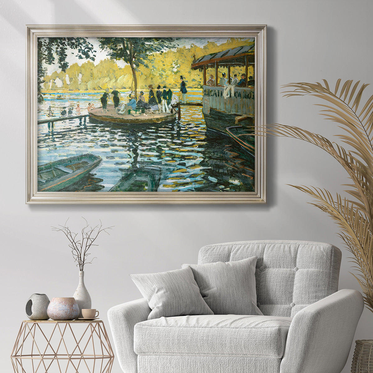 Impressionist riverside leisure scene by Claude Monet in an ornate champagne frame displayed in a bright interior setting.