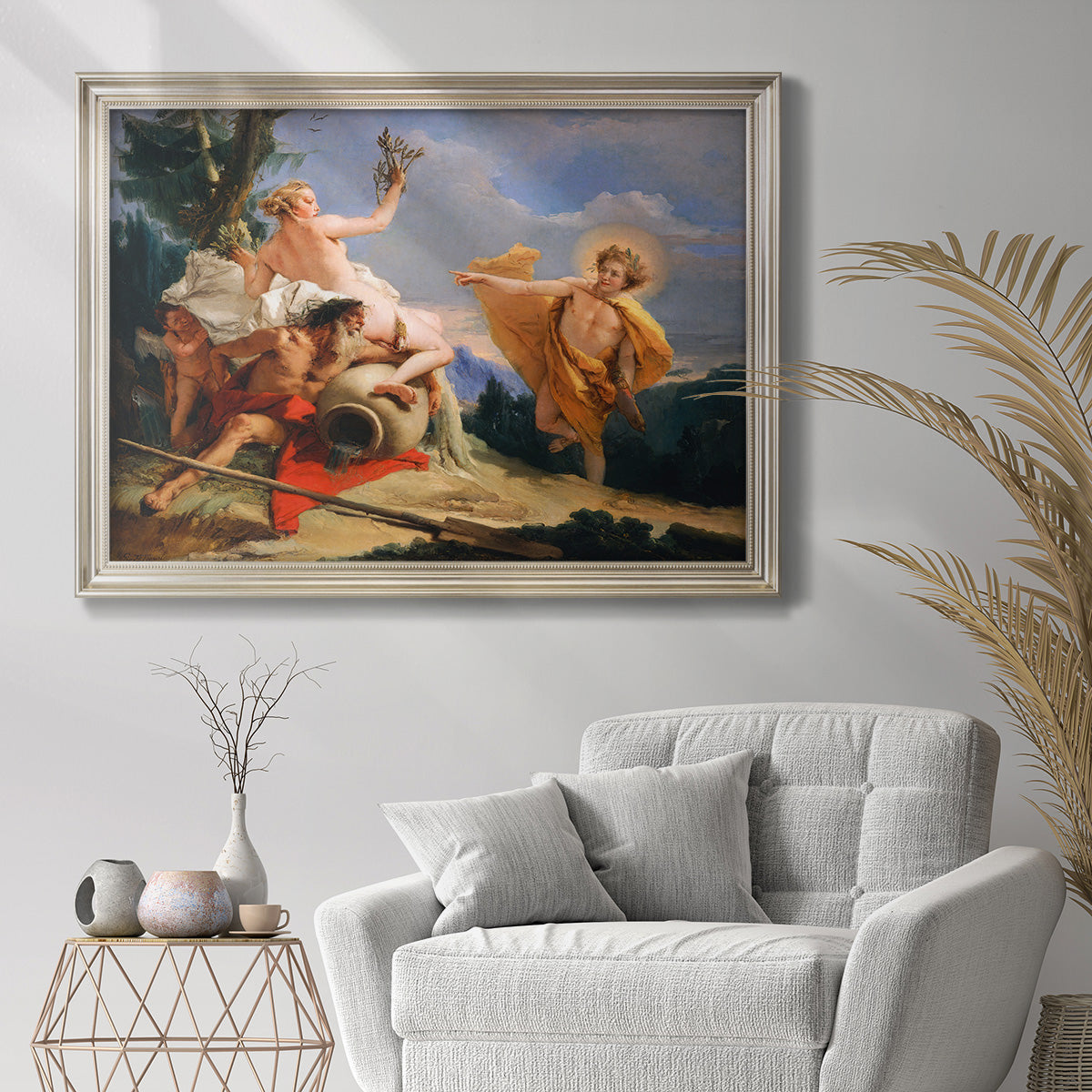 Classical mythological painting of Apollo and Daphne by Giovanni Battista Tiepolo in an ornate champagne frame displayed in a bright interior setting.