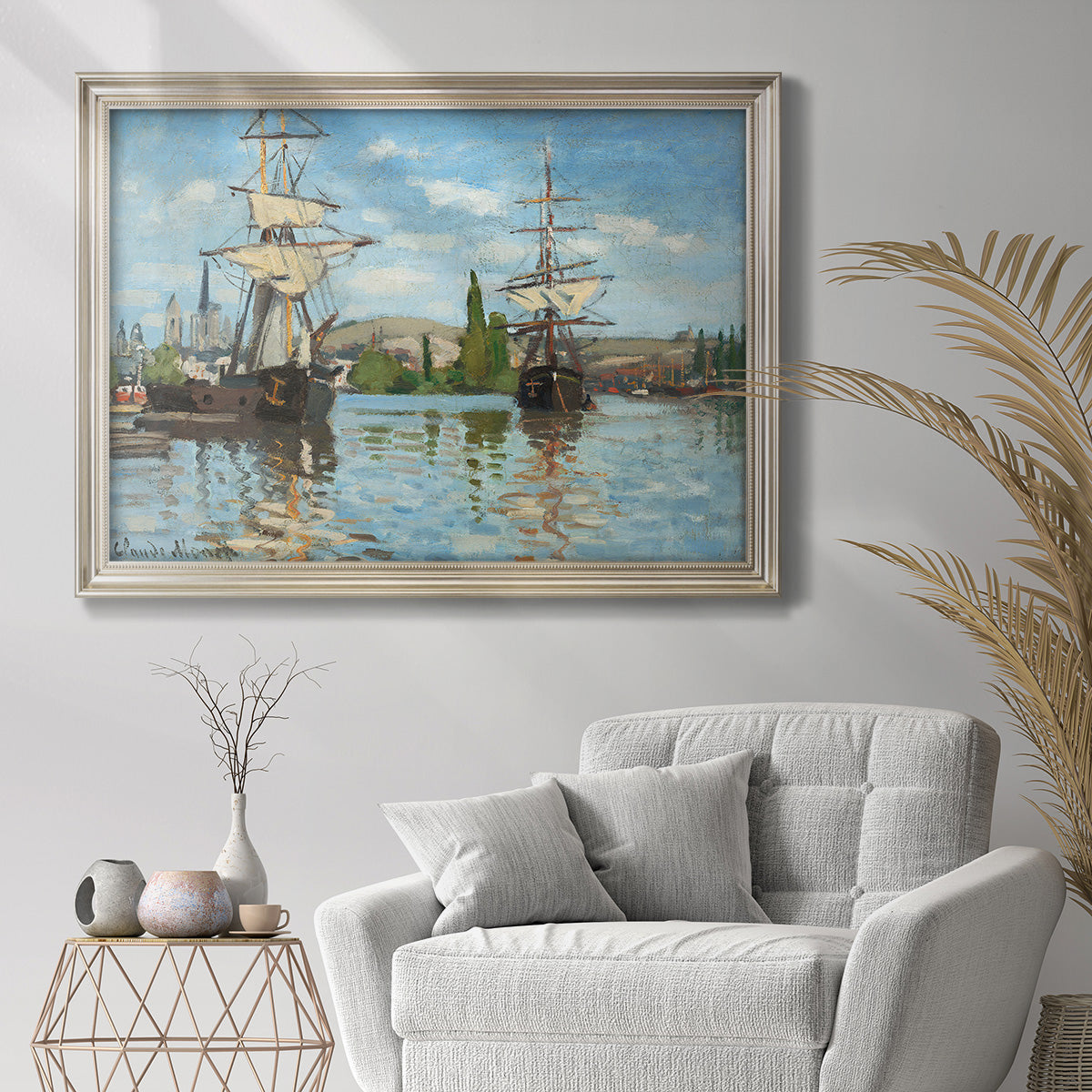 Impressionist river scene with boats on the Seine by Claude Monet in an ornate champagne frame displayed in a bright interior setting.