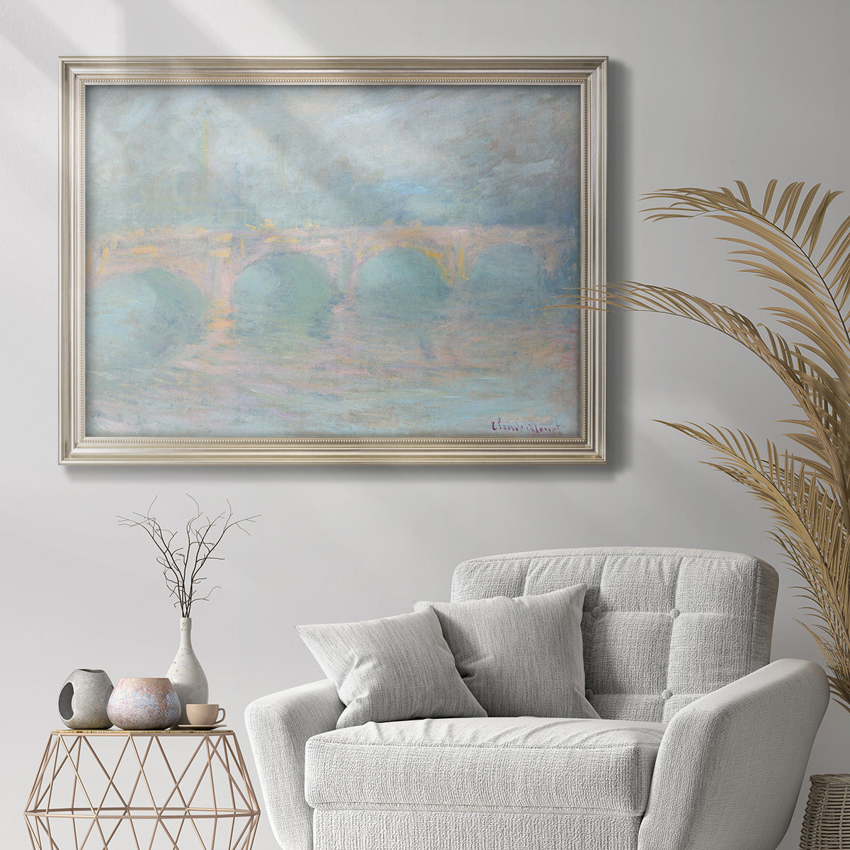 Impressionist sunset view of Waterloo Bridge by Claude Monet in an ornate champagne frame displayed in a bright interior setting.