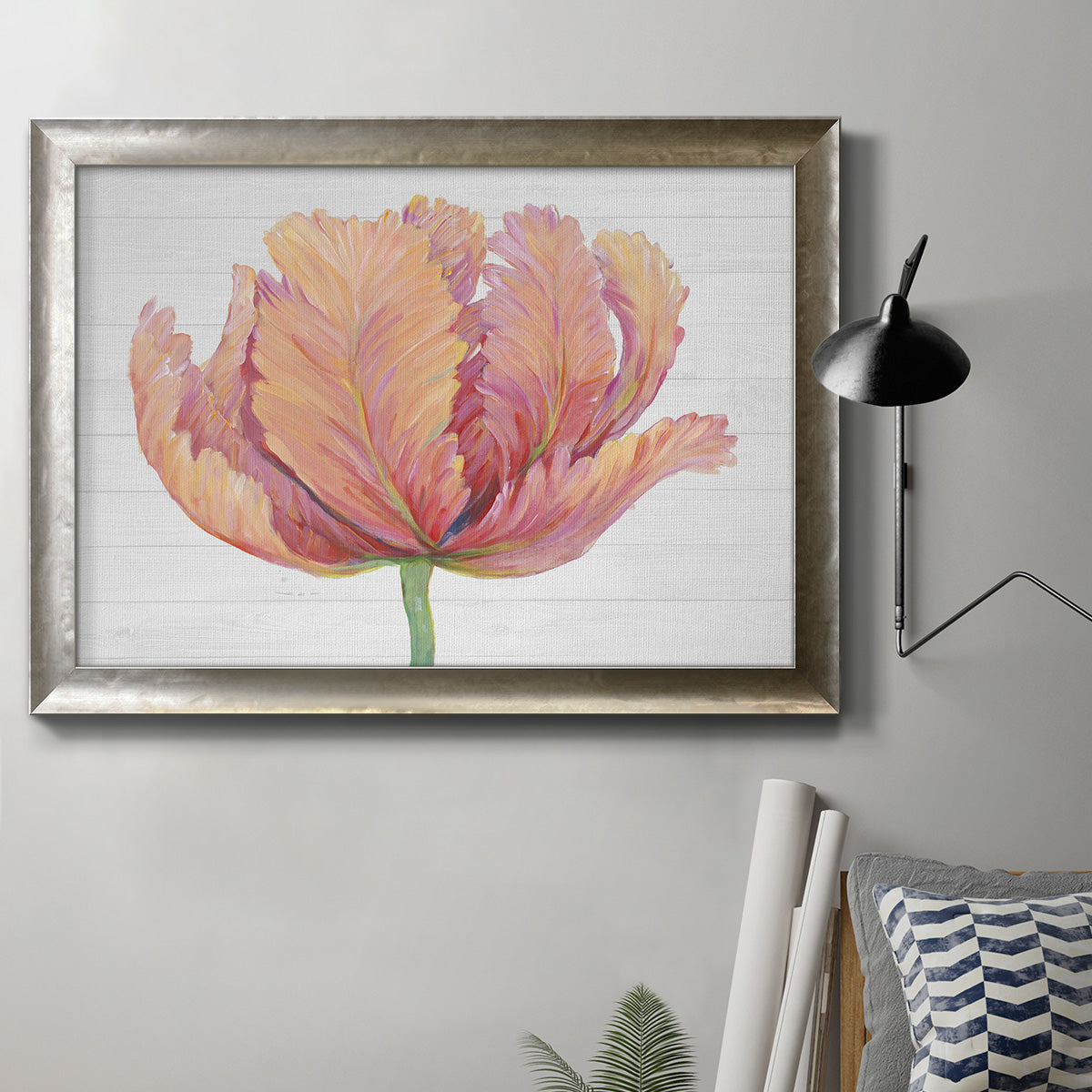 Minimalist pink flower abstract artwork in an ornate mottled silver frame displayed in a neutral interior setting.