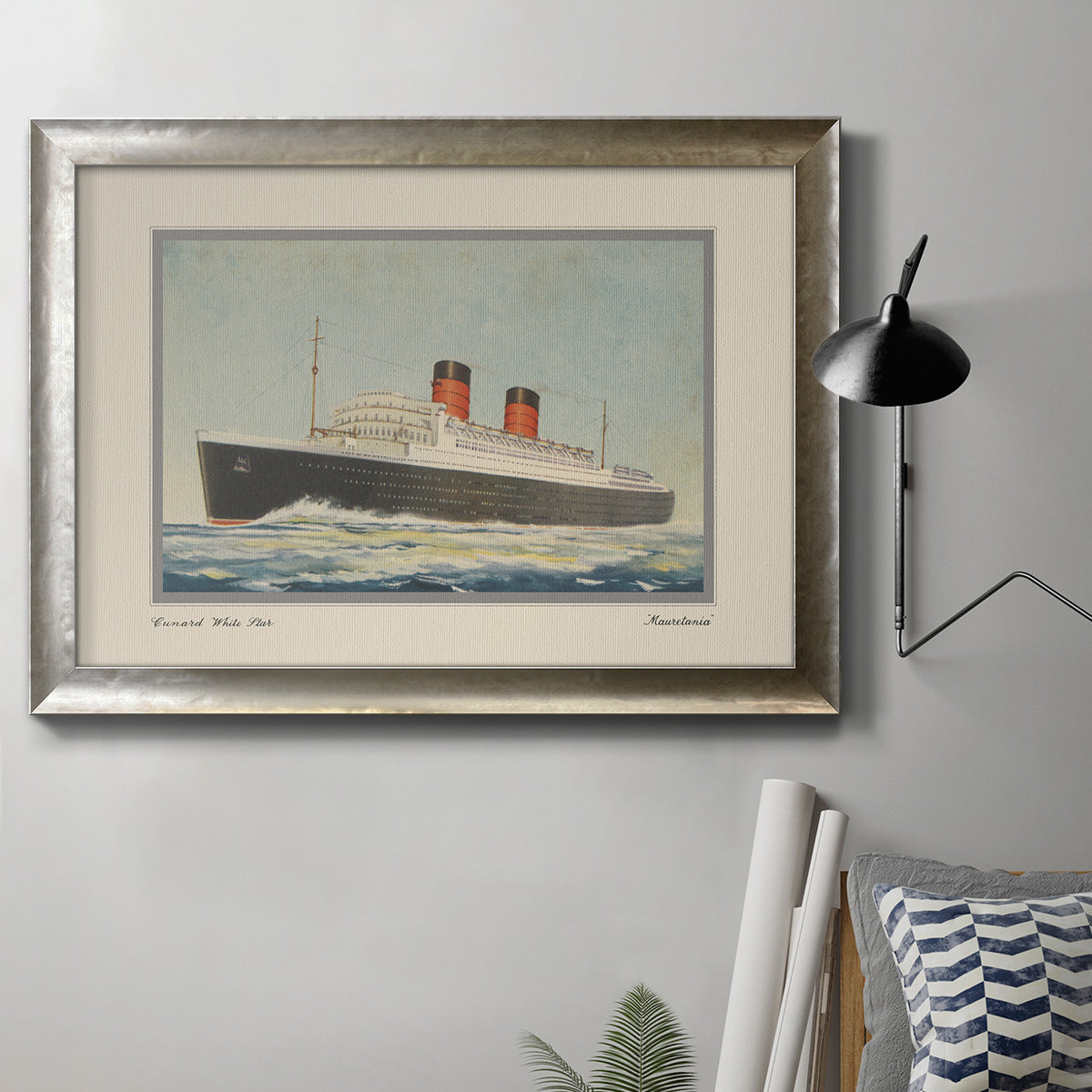 Vintage nautical cruise ship illustration in an ornate mottled silver frame displayed in a neutral interior setting.