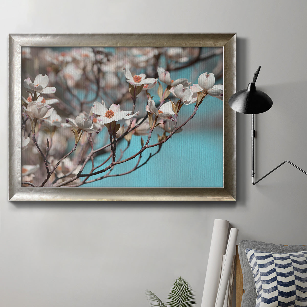 Color-rich dogwood floral photography in an ornate mottled silver frame displayed in a neutral interior setting.