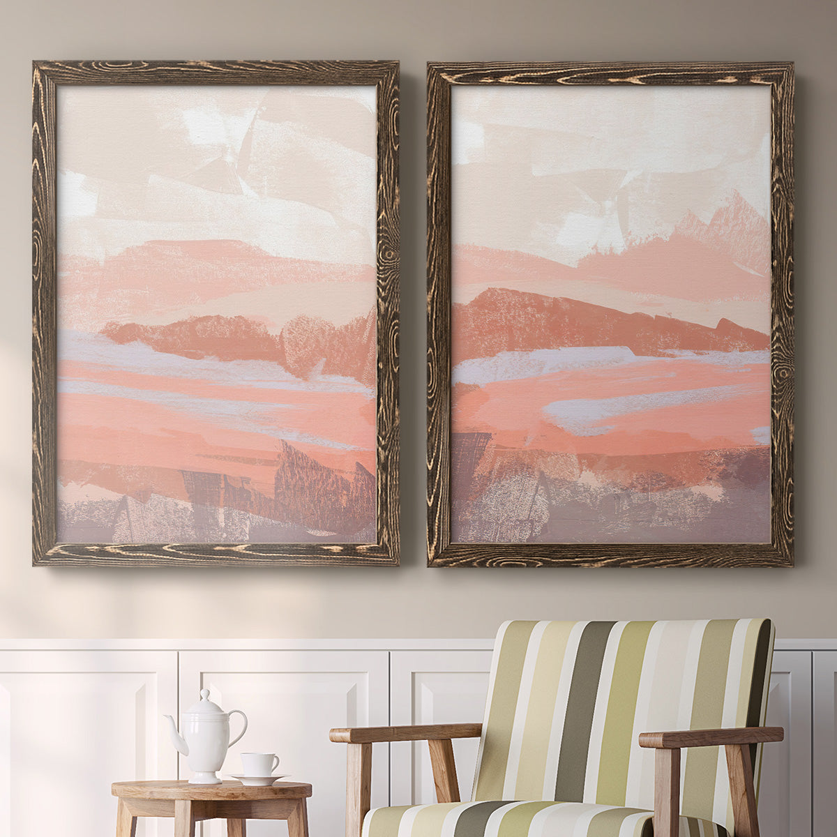 Set of two walnut barnwood framed canvas prints depicting two modern abstract landscapes featuring layered blush terracotta and blue desert horizons above a sideboard in a cozy sitting room.