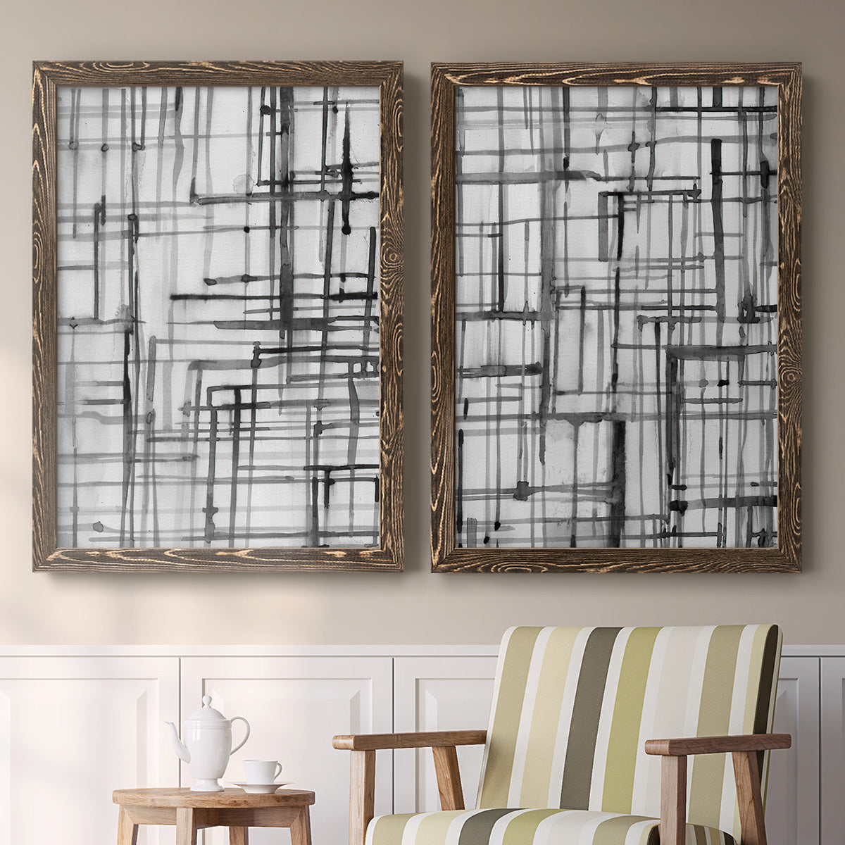 Set of two walnut barnwood framed canvas prints depicting two monochrome geometric abstracts featuring layered black linear grids above a sideboard in a cozy sitting room.