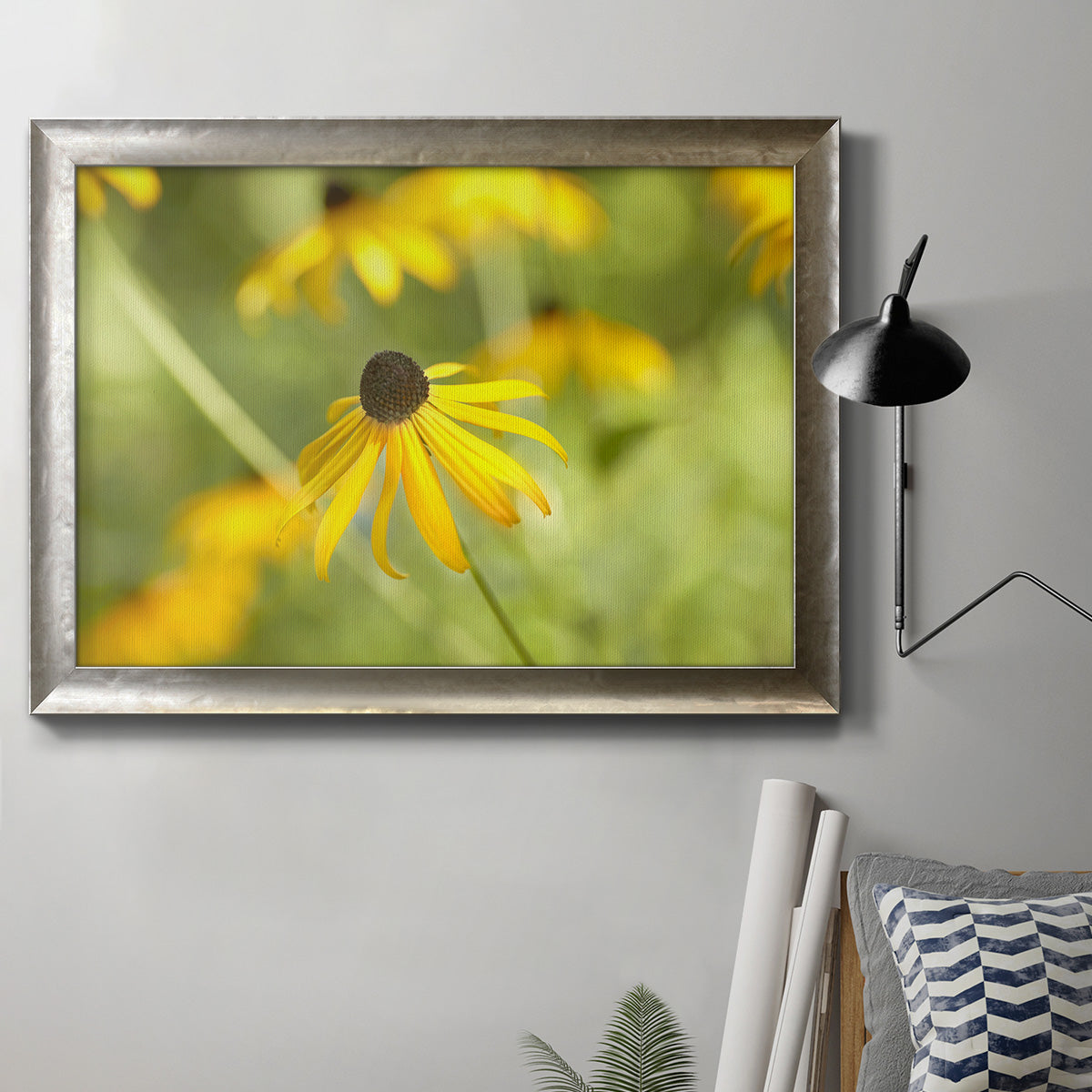 Contemporary black-eyed Susan flower photography in an ornate mottled silver frame displayed in a neutral interior setting.