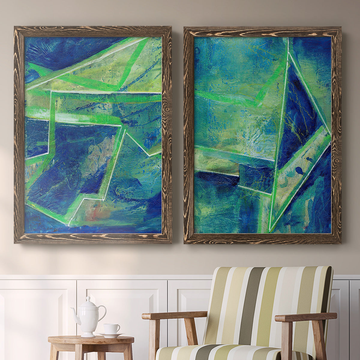 Set of two walnut barnwood framed canvas prints depicting two textured geometric abstracts featuring interlocking blue and green angular forms above a sideboard in a cozy sitting room.