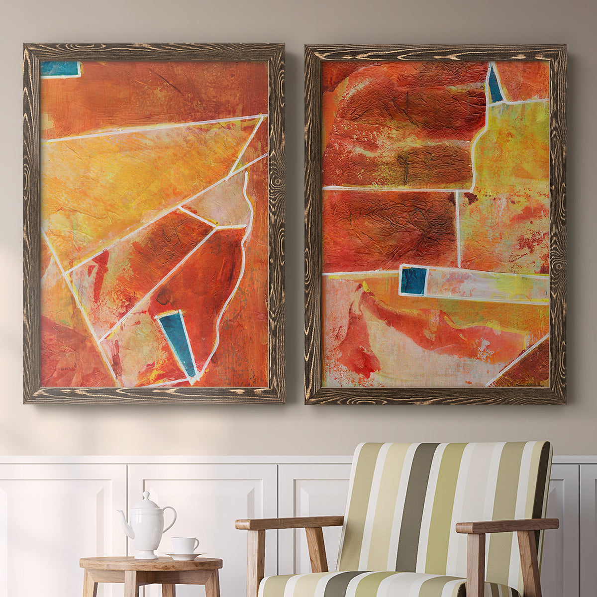 Set of two walnut barnwood framed canvas prints depicting two warm geometric abstracts featuring faceted rust orange and coral geometric fields above a sideboard in a cozy sitting room.