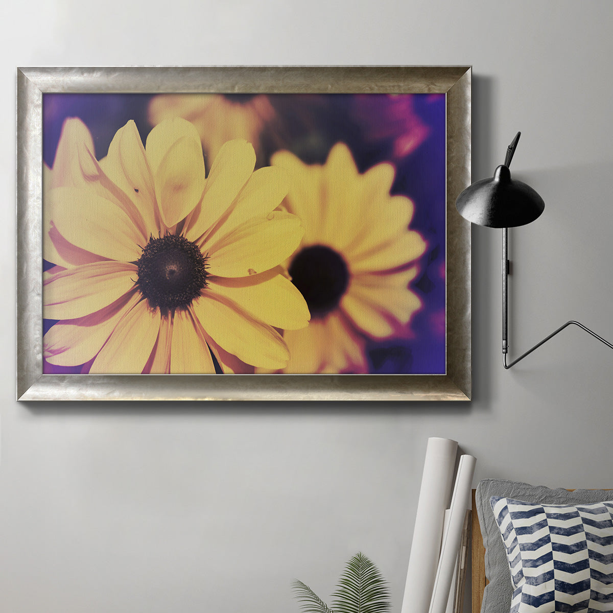 Bright black-eyed Susan flower photography in an ornate mottled silver frame displayed in a neutral interior setting.