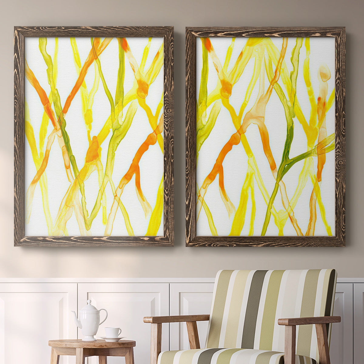 Set of two walnut barnwood framed canvas prints depicting two fluid organic abstracts featuring branching watercolor lines drifting across white above a sideboard in a cozy sitting room.