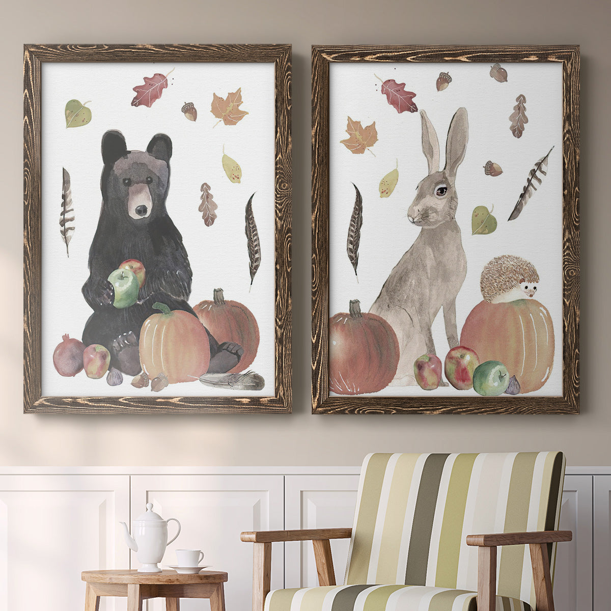 Set of two walnut barnwood framed canvas prints depicting a watercolor woodland animal pair with a bear rabbit hedgehog pumpkins fruit acorns and falling leaves above a sideboard in a cozy sitting room.