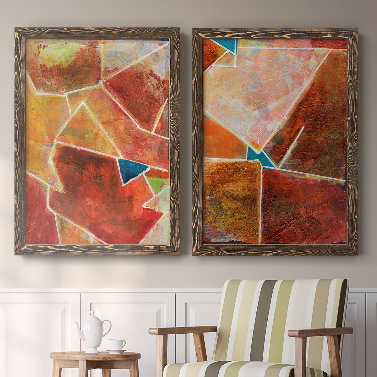 Set of two walnut barnwood framed canvas prints depicting two warm geometric abstracts featuring faceted rust orange and coral geometric fields above a sideboard in a cozy sitting room.