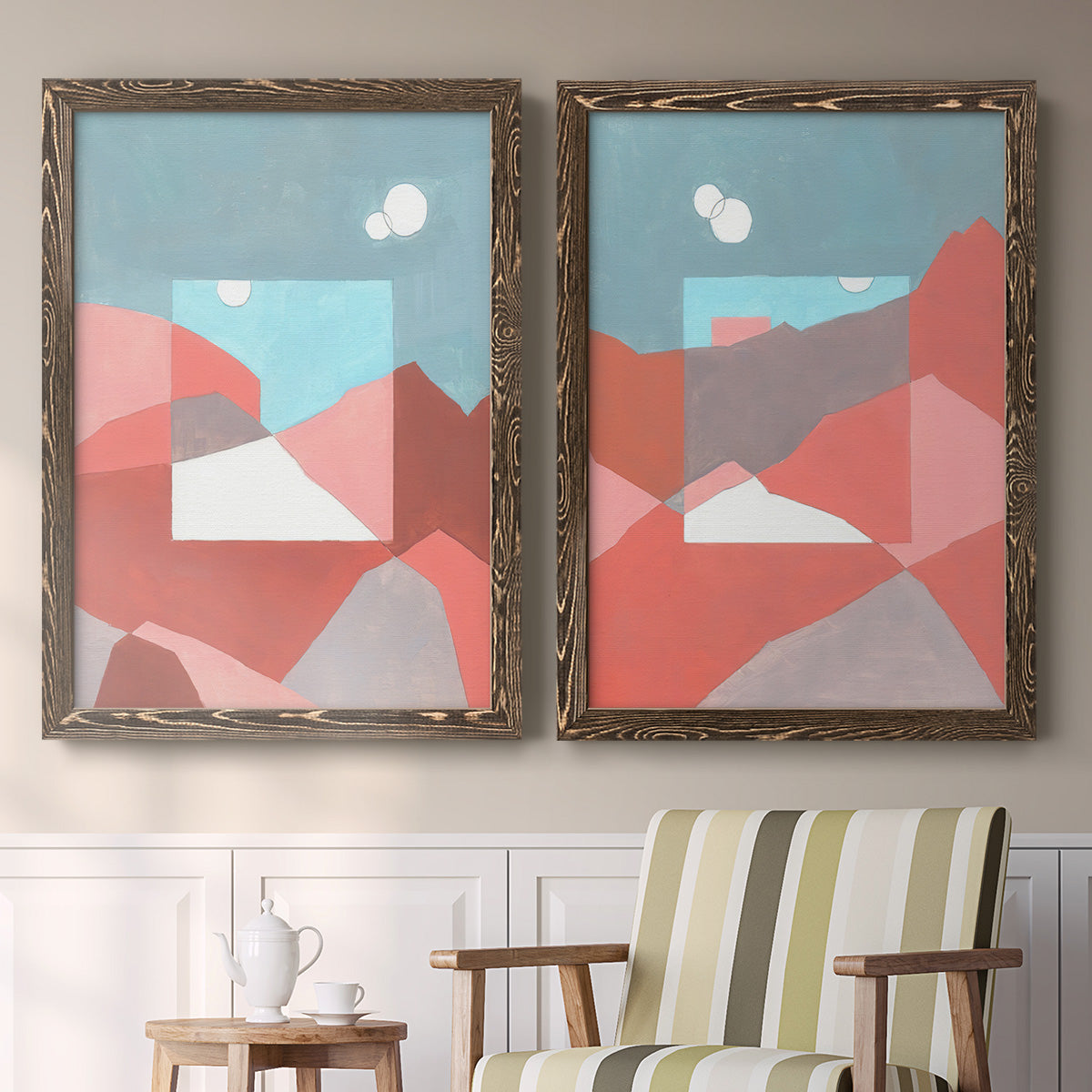 Set of two walnut barnwood framed canvas prints depicting two modern abstract landscapes featuring layered red coral and turquoise desert-like geometry above a sideboard in a cozy sitting room.