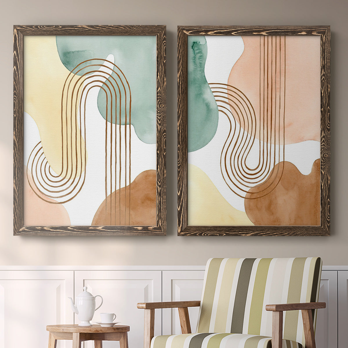 Set of two walnut barnwood framed canvas prints depicting two folk-inspired botanical patterns featuring repeating indigo floral and leaf motifs above a sideboard in a cozy sitting room.