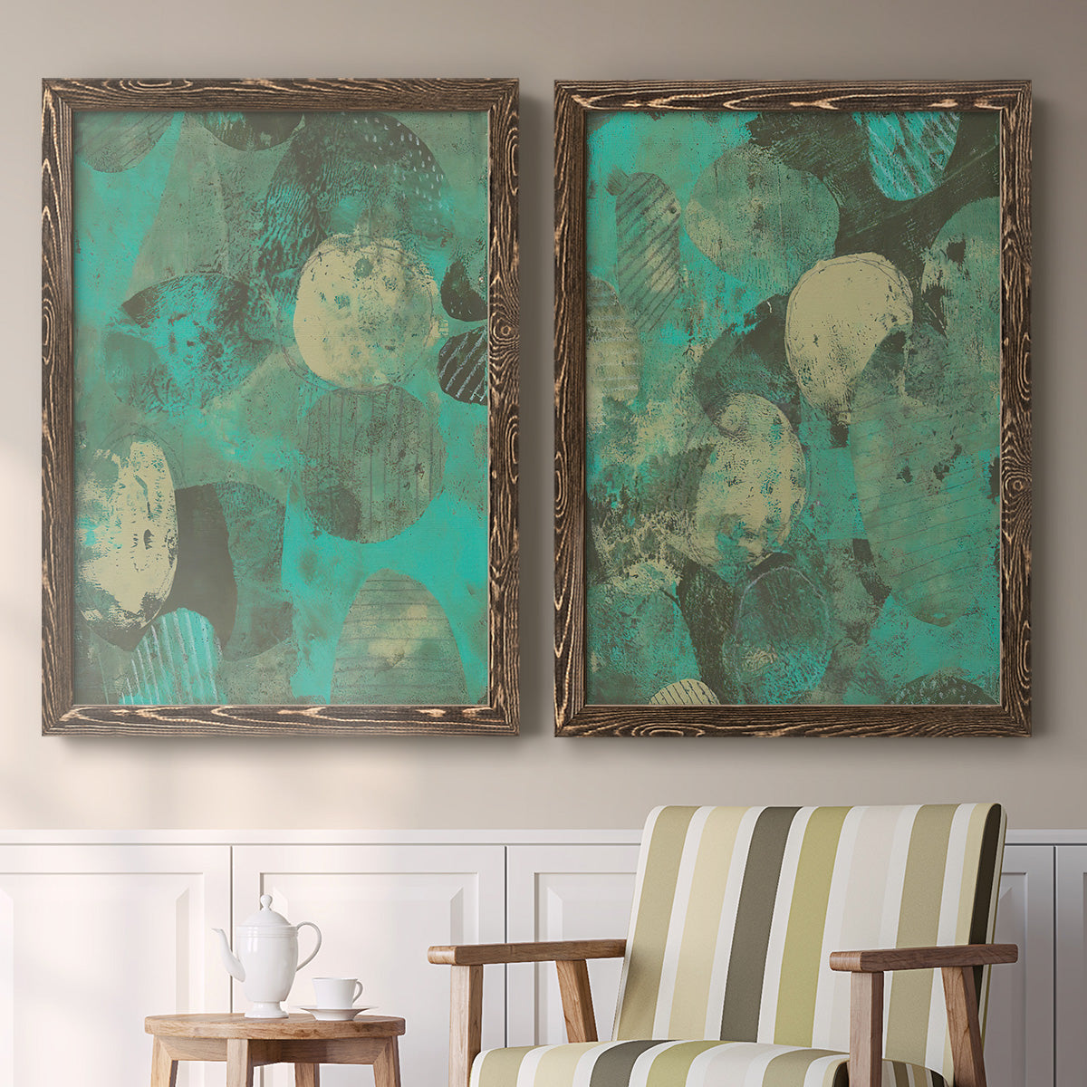 Set of two walnut barnwood framed canvas prints depicting two textured organic abstracts featuring layered mint teal and beige circular forms above a sideboard in a cozy sitting room.