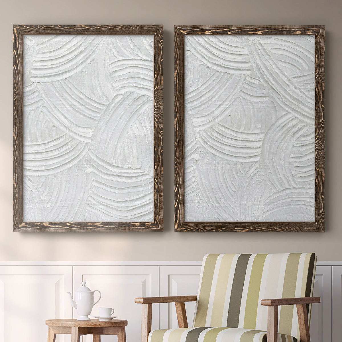 Set of two walnut barnwood framed canvas prints depicting two textural monochrome abstracts featuring overlapping white carved arcs and ridges above a sideboard in a cozy sitting room.