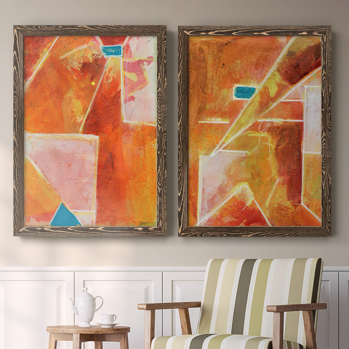 Set of two walnut barnwood framed canvas prints depicting two warm geometric abstracts featuring faceted rust orange and coral geometric fields above a sideboard in a cozy sitting room.