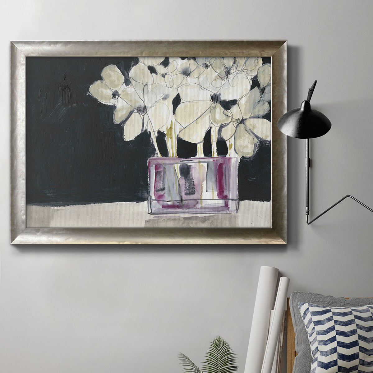 Modern abstract white floral watercolor artwork in an ornate mottled silver frame displayed in a neutral interior setting.