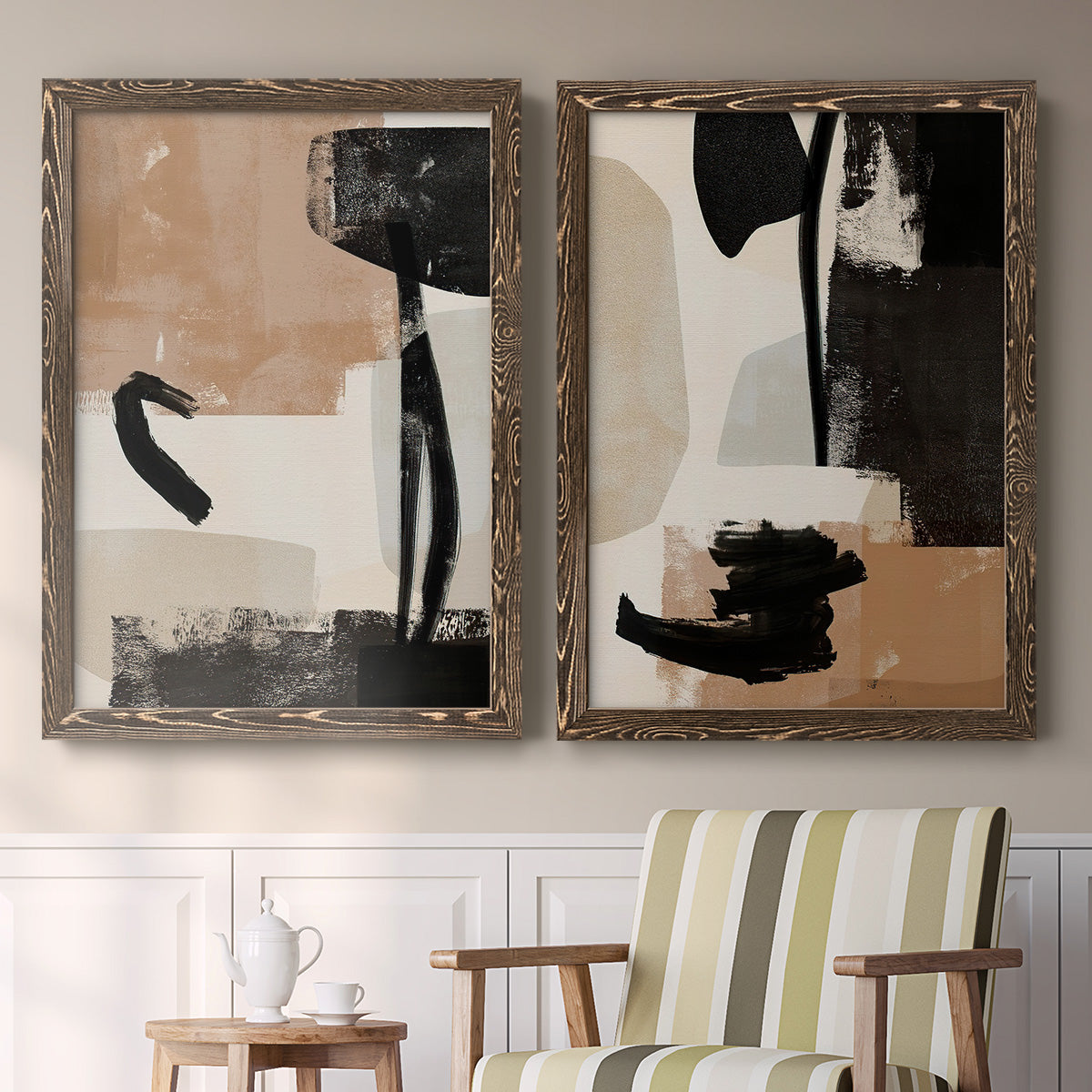 Set of two walnut barnwood framed canvas prints depicting two minimalist collage-like abstracts featuring black taupe cream and beige painted forms above a sideboard in a cozy sitting room.
