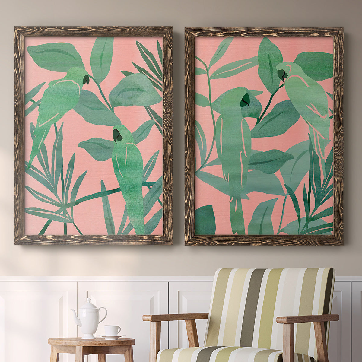 Set of two walnut barnwood framed canvas prints depicting two bold tropical botanical prints featuring large green tropical leaves on coral-pink grounds above a sideboard in a cozy sitting room.