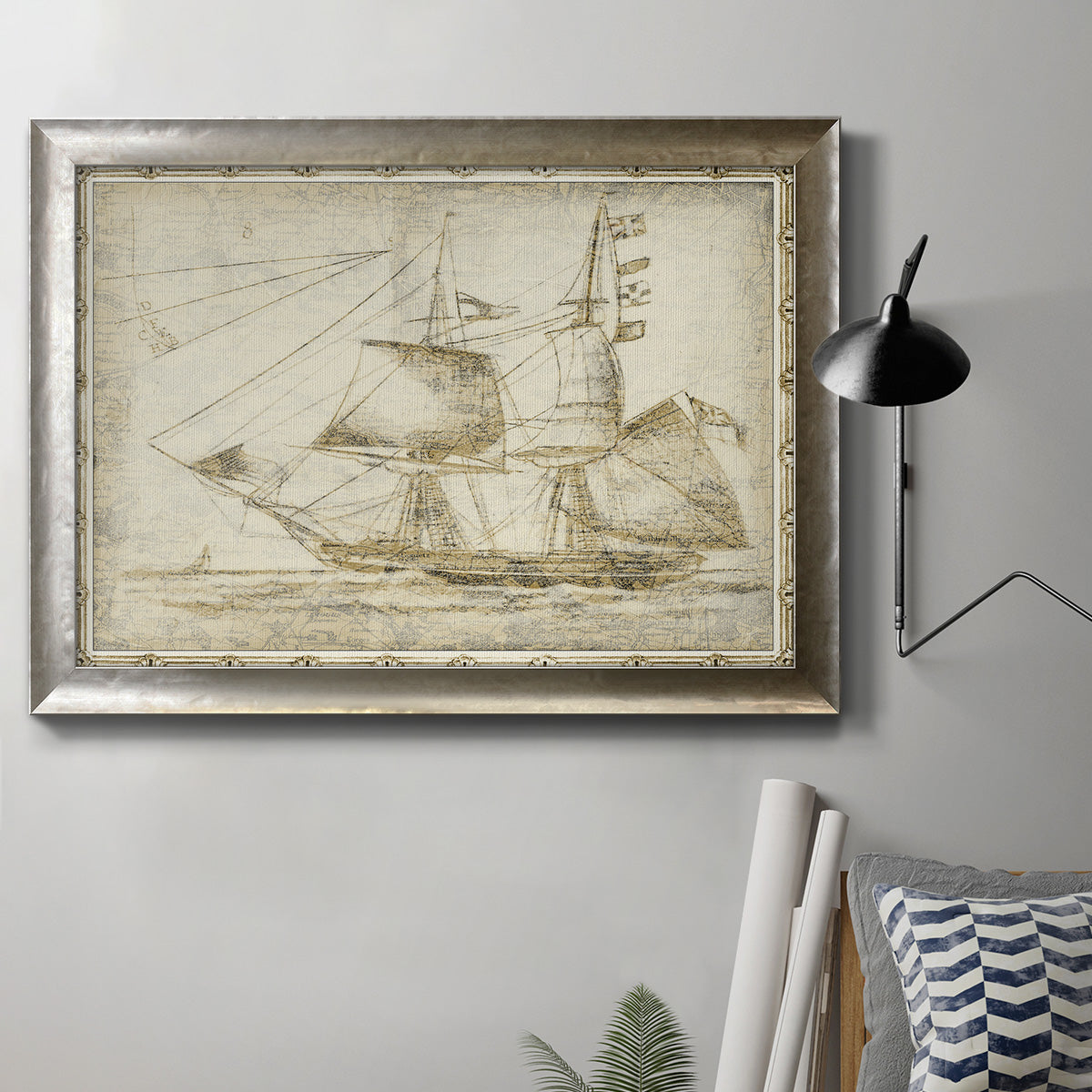 Vintage ghost ship maritime illustration in an ornate mottled silver frame displayed in a neutral interior setting.