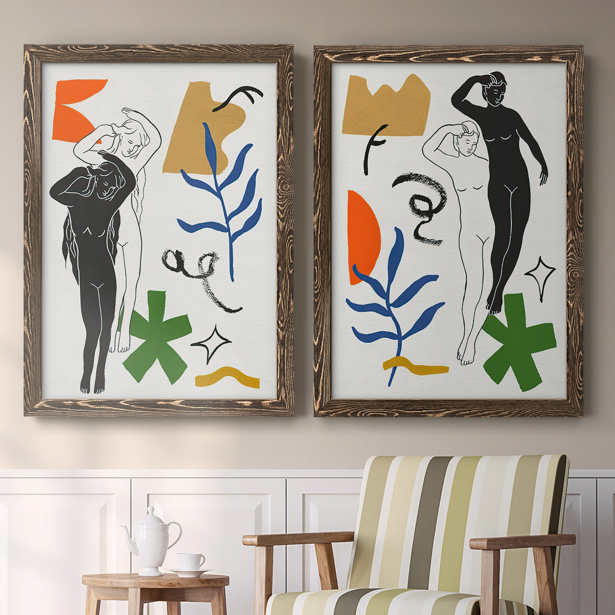 Set of two walnut barnwood framed canvas prints depicting two graphic figurative collages of women with bold botanical shapes stars and abstract symbols above a sideboard in a cozy sitting room.