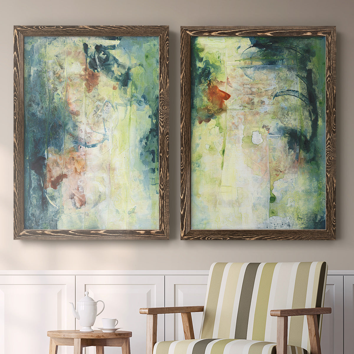 Set of two walnut barnwood framed canvas prints depicting two nature-inspired mixed-media abstracts featuring layered blue green cream and charcoal textures above a sideboard in a cozy sitting room.