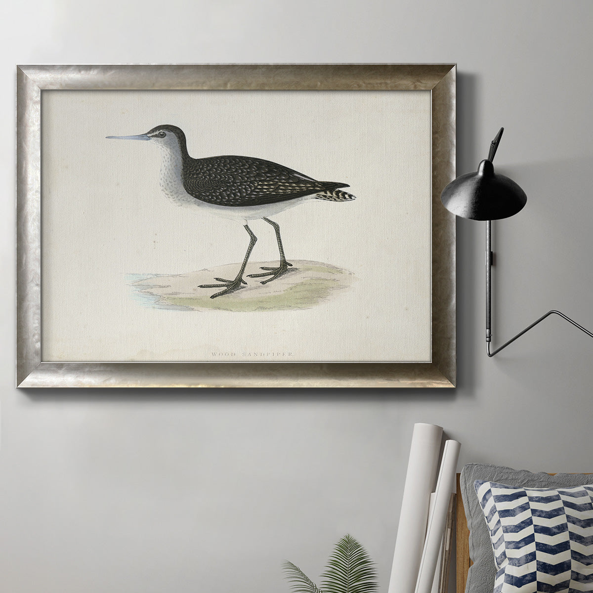 Antique sandpiper bird illustration with typographic elements by William Morris in an ornate mottled silver frame displayed in a neutral interior setting.