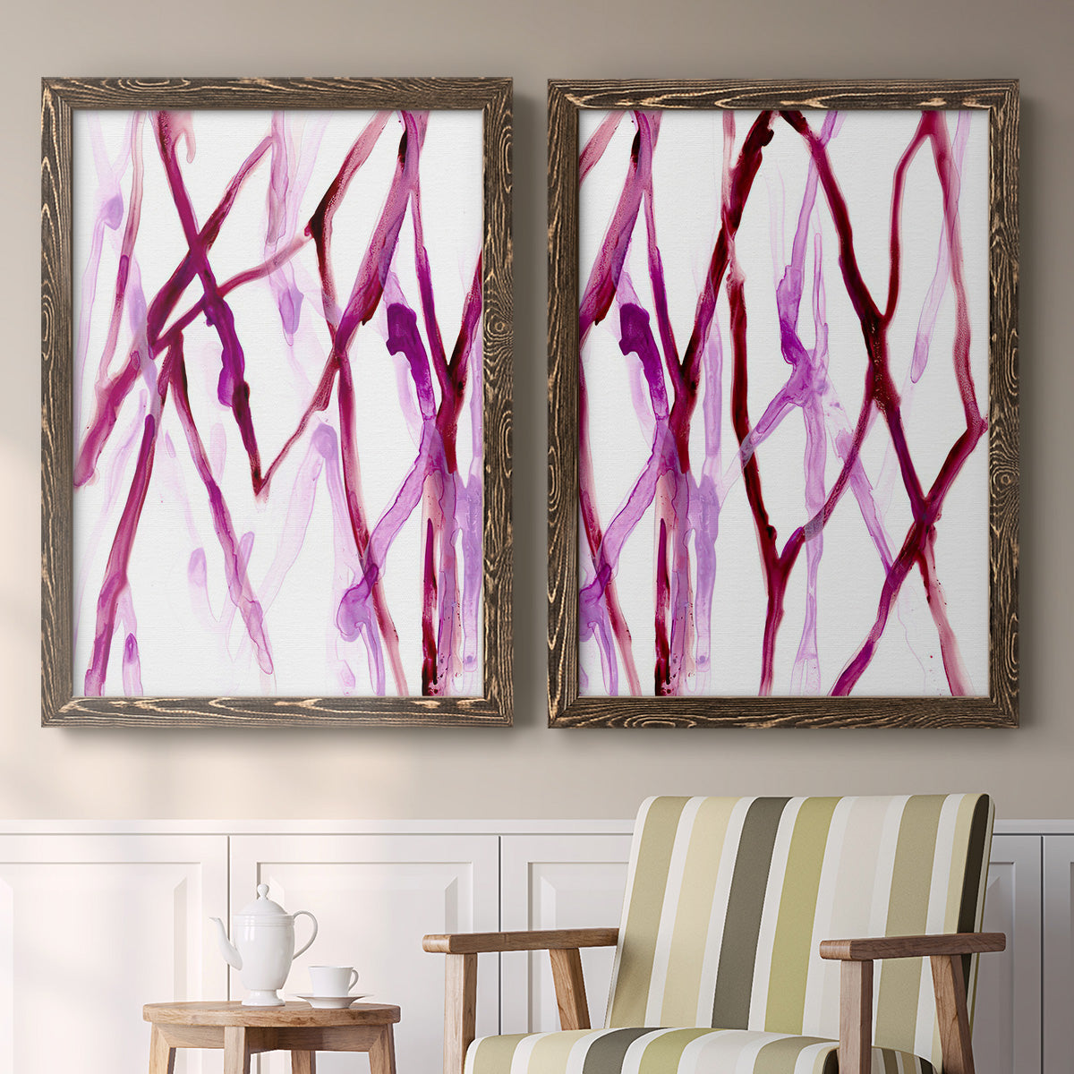 Set of two walnut barnwood framed canvas prints depicting two fluid organic abstracts featuring branching watercolor lines drifting across white above a sideboard in a cozy sitting room.