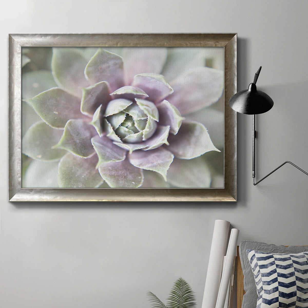 Soft abstract floral botanical photography in an ornate mottled silver frame displayed in a neutral interior setting.