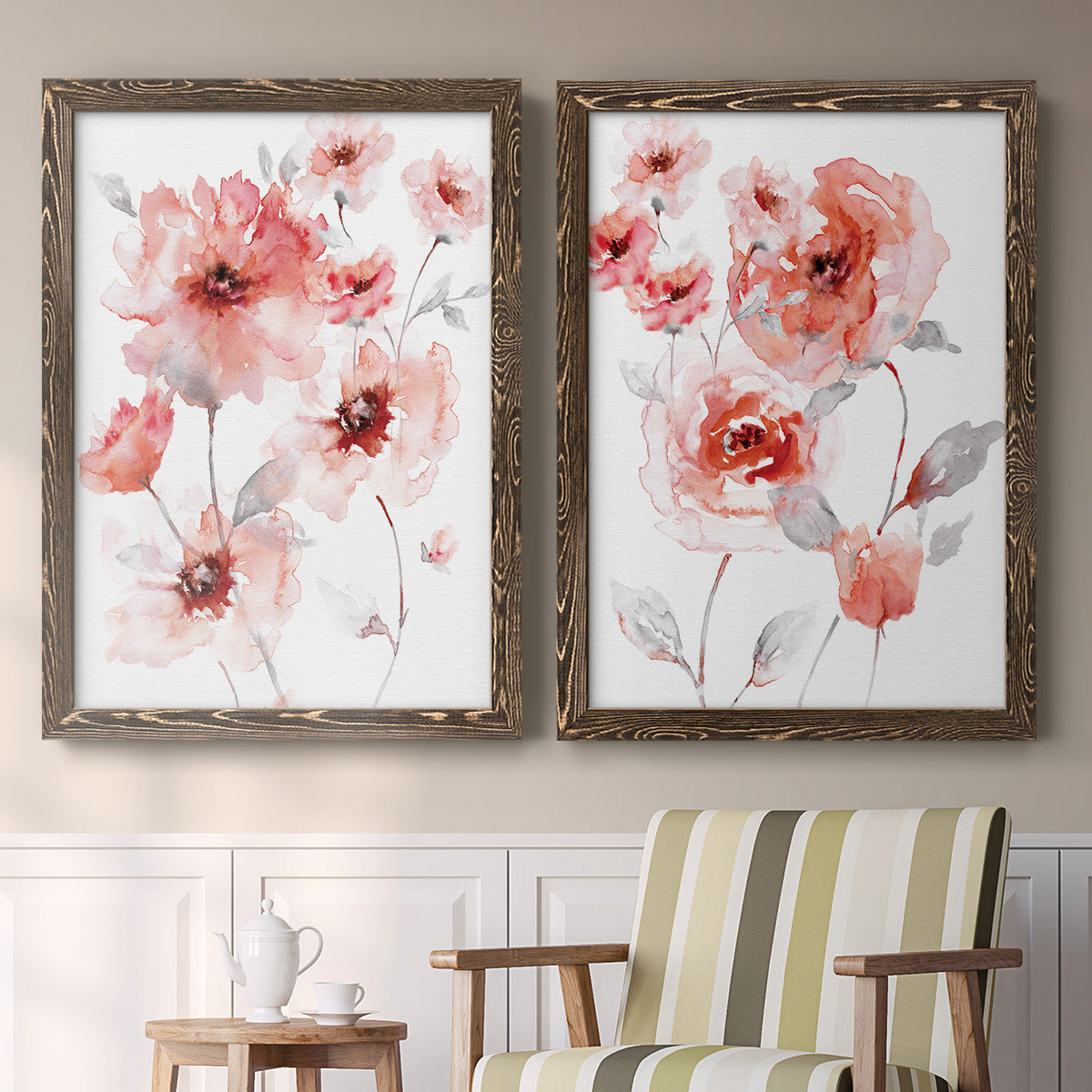 Set of two walnut barnwood framed canvas prints depicting two airy contemporary watercolor florals featuring loose coral pink blossoms on slender gray stems above a sideboard in a cozy sitting room.