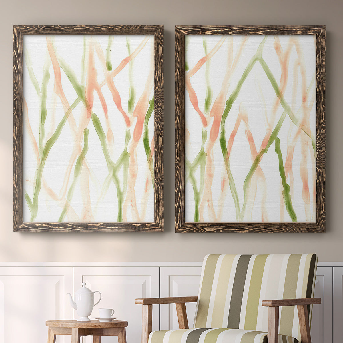 Set of two walnut barnwood framed canvas prints depicting two fluid organic abstracts featuring branching watercolor lines drifting across white above a sideboard in a cozy sitting room.