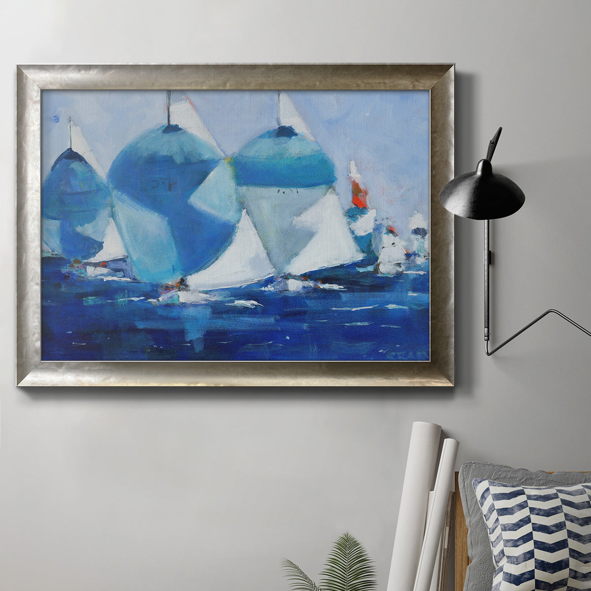Coastal nautical watercolor painting in an ornate mottled silver frame displayed in a neutral interior setting.