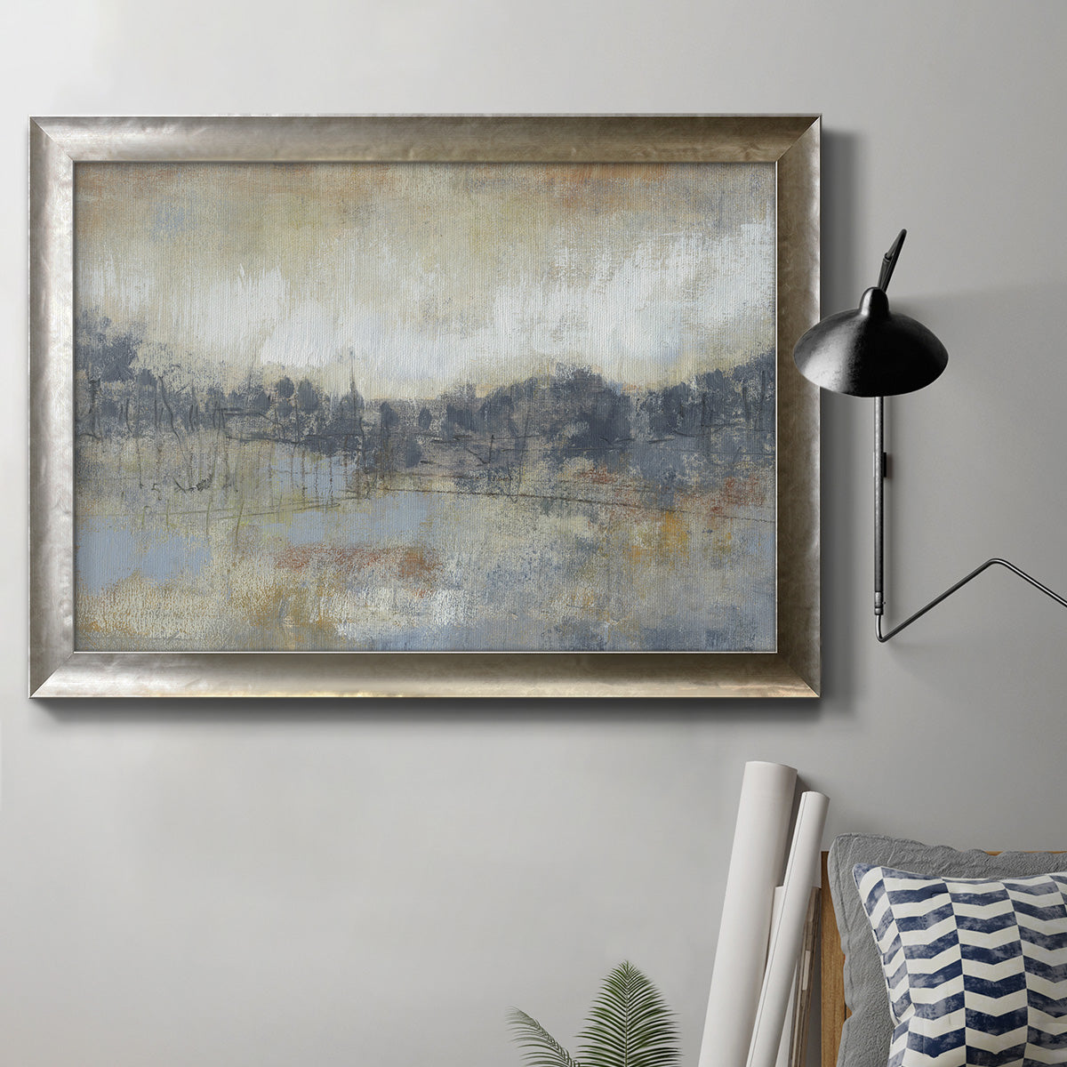 Abstract modern landscape artwork in an ornate mottled silver frame displayed in a neutral interior setting.